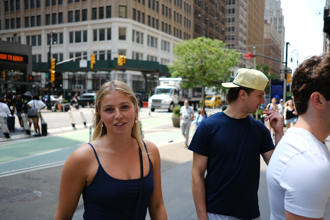 Friends talking while walking along a city street