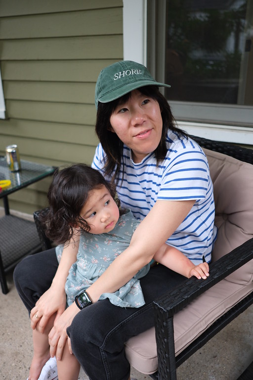 A mother and child sharing a quiet moment on a porch
